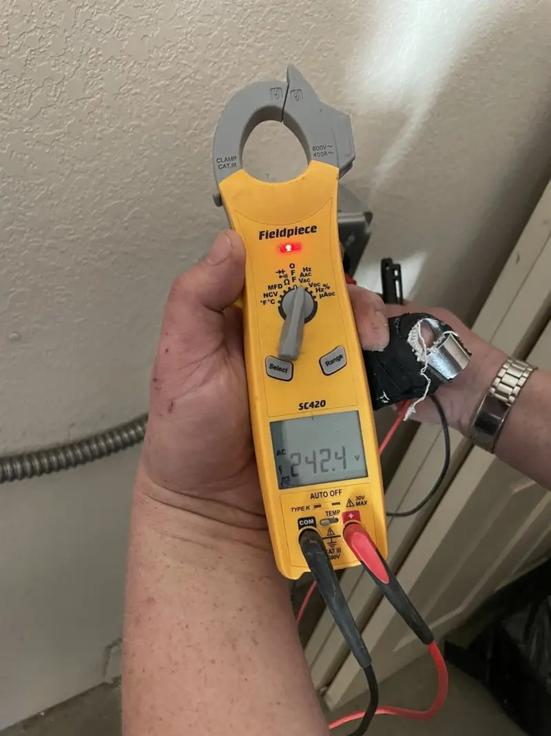 Voltage testing with clamp meter during Recessed Lighting Installation in Doraville